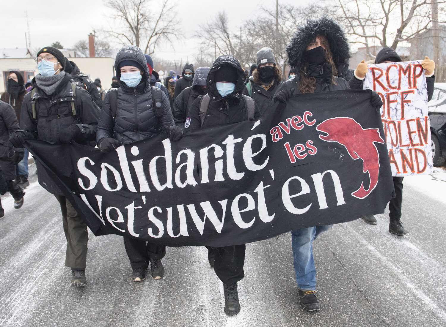 Protesters march following a blockade of a CN rail line in solidarity with Wet’suwet’en land defenders in St-Lambert, Que., Saturday, Dec. 4, 2021.