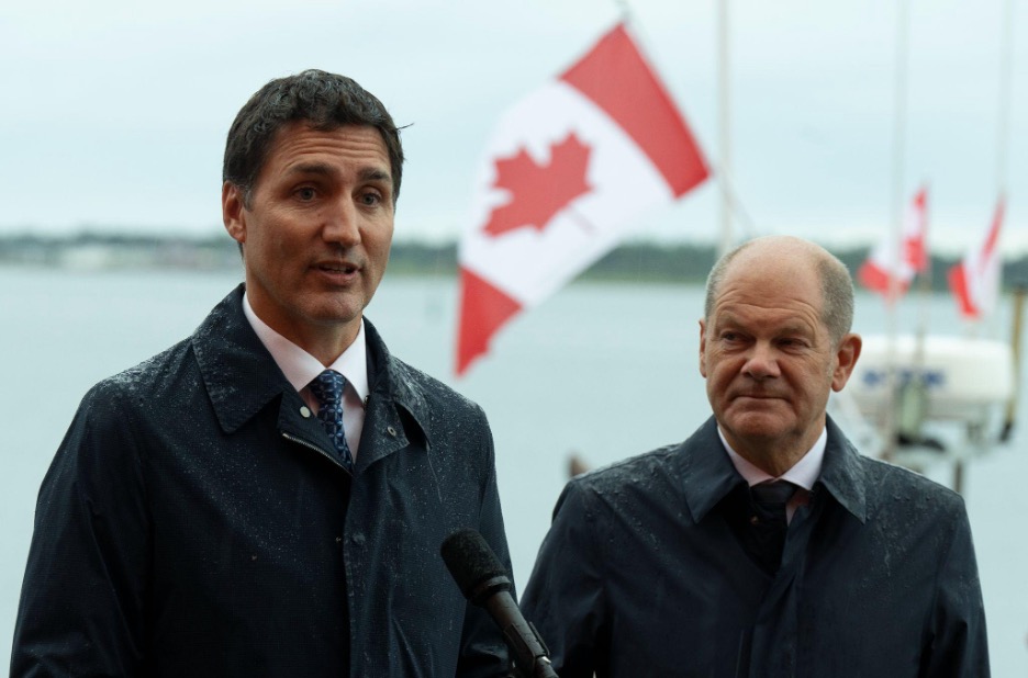 German Chancellor Olaf Scholz looks on as Canadian Prime Minister Justin Trudeau responds to a question during joint media availability on Tuesday, August 23, 2022 in Stephenville, Newfoundland and Labrador. THE CANADIAN PRESS/Adrian Wyld.
